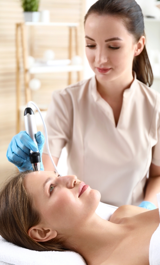 A woman undergoing a laser anti-ageing therapy at a cosmetic laser center.