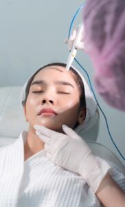 A woman undergoing a laser acne treatment procedure on her face with the help of a skin expert.