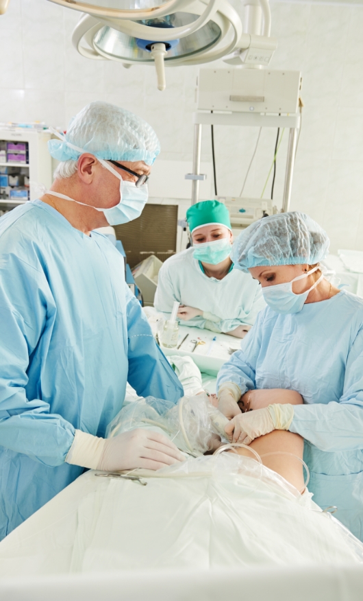 Cosmetic experts performing a varicose vein treatment procedure in an operation theatre.