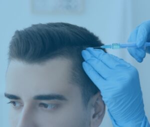A close-up shot of a male patient getting a shot on his scalp as part of his anti-hair fall treatment.