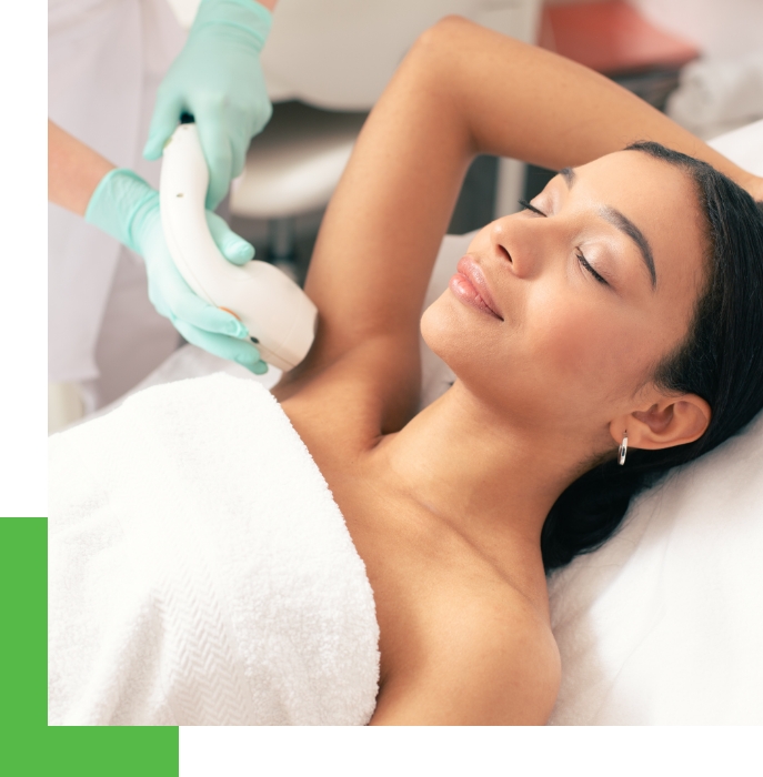 At a laser skin care clinic, a female patient undergoes laser hair removal treatment on her underarms.