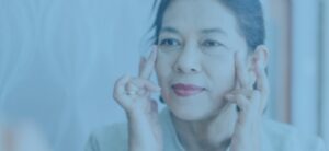 A close-up shot of a female patient checking her face after the laser antiaging treatment.